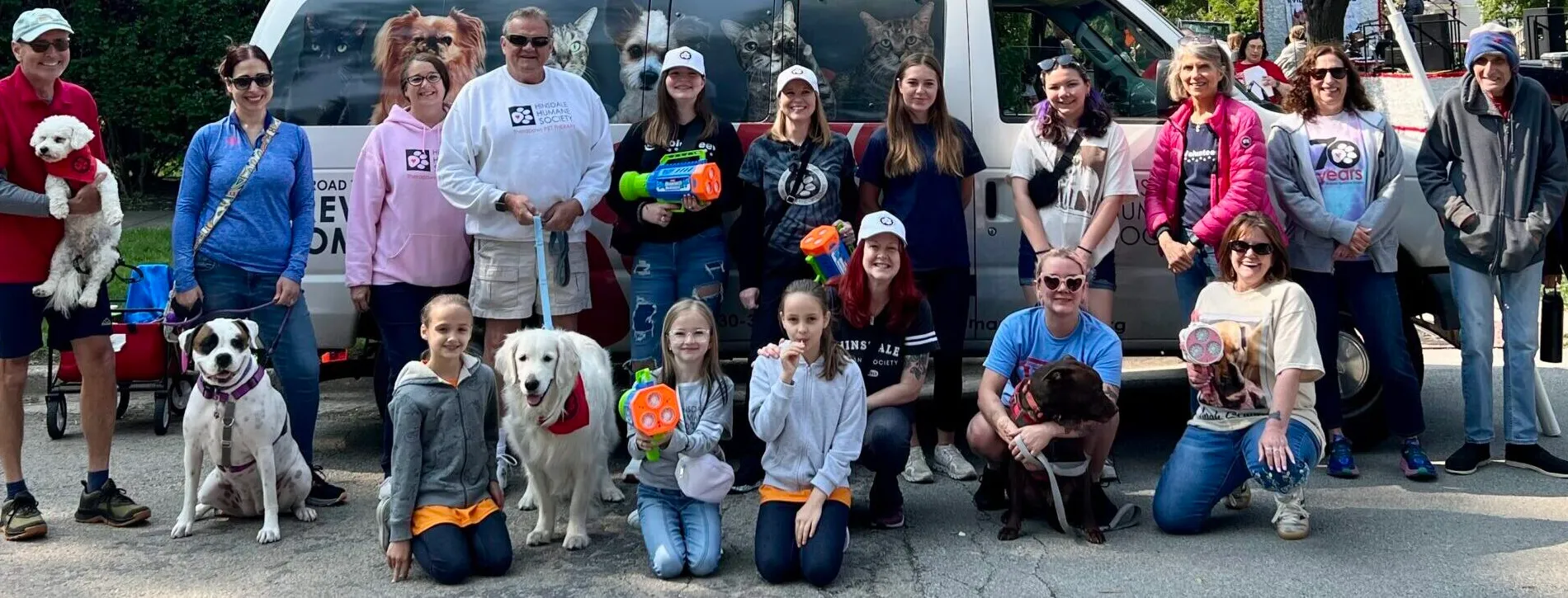 diverse group of volunteers pictured with dogs